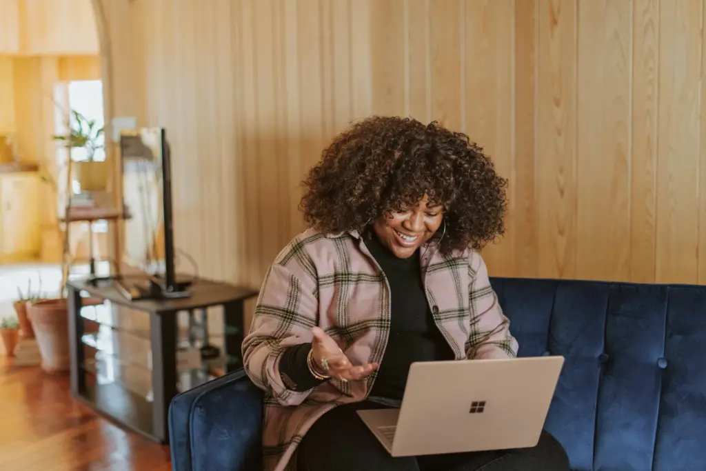Woman sitting at her laptop on a video call with her life coach